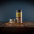 Bourbon Barrel Foods Bourbon Smoked Citrus Pepper in a shaker and a tin.